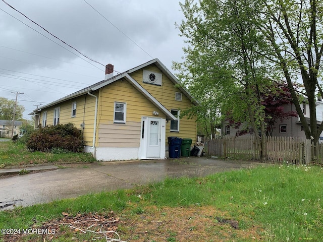 exterior space with fence and a chimney