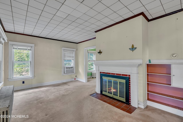 unfurnished living room with cooling unit, ornamental molding, and carpet