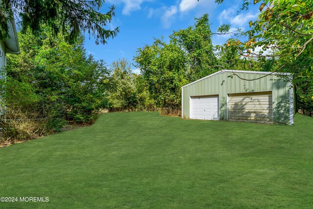 view of yard featuring an outbuilding and a garage