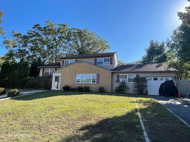 view of property featuring a front lawn and a garage