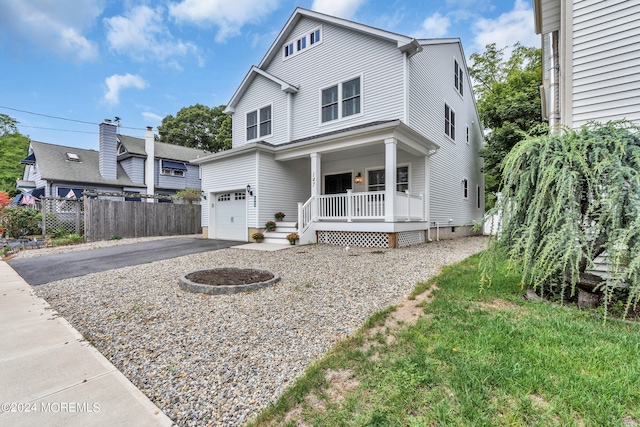 view of front facade with a garage and a porch