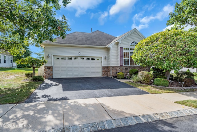 view of front of property with a garage and a front yard