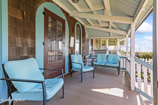 balcony featuring outdoor lounge area and a porch