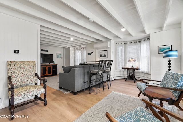 living room featuring light hardwood / wood-style flooring, wood walls, beam ceiling, and a wall mounted AC