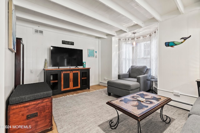 living room with a baseboard heating unit, beam ceiling, and light hardwood / wood-style flooring