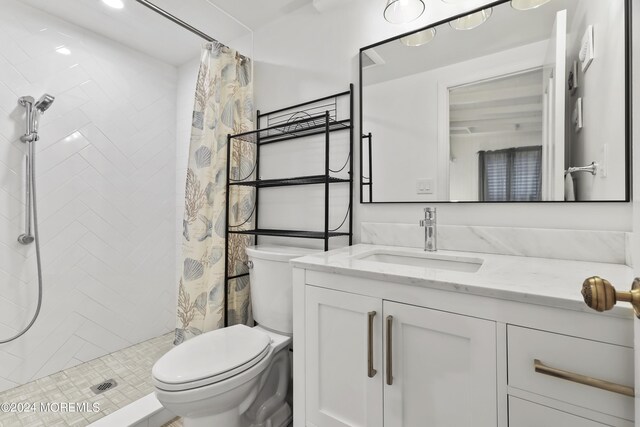 bathroom featuring curtained shower, toilet, and vanity