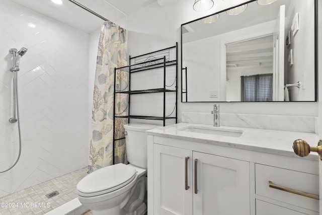 bathroom featuring vanity, toilet, and a shower stall