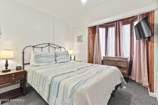 bedroom featuring carpet and vaulted ceiling