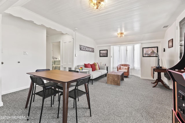 dining room featuring carpet floors, visible vents, and baseboards