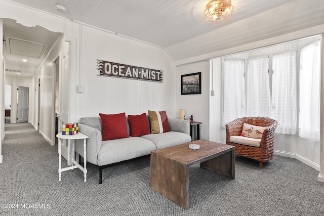 living area with lofted ceiling, carpet, attic access, and baseboards