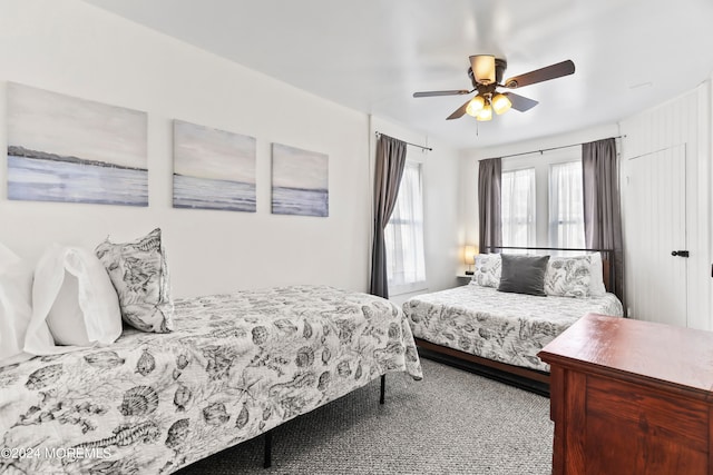 bedroom featuring ceiling fan and light carpet