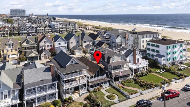 birds eye view of property with a beach view and a water view