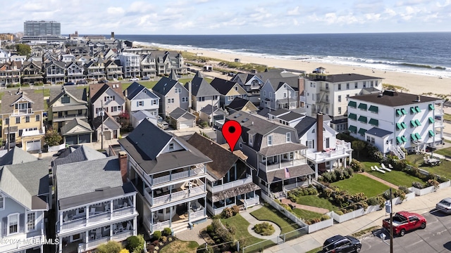 bird's eye view with a water view and a view of the beach