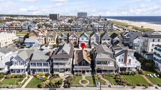 aerial view with a water view and a beach view