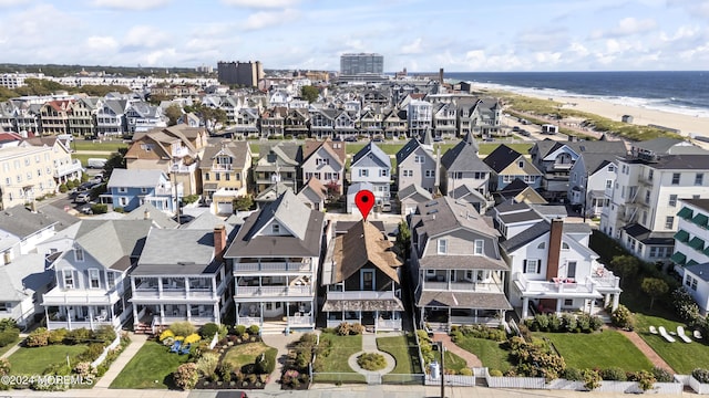 aerial view with a residential view, a water view, and a beach view