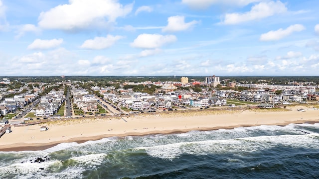 drone / aerial view featuring a view of the beach and a water view