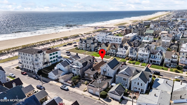 drone / aerial view with a beach view and a water view