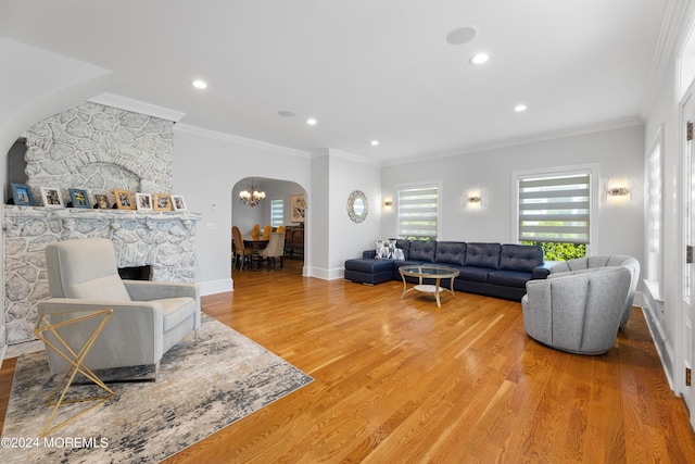 living room with crown molding, an inviting chandelier, and wood-type flooring