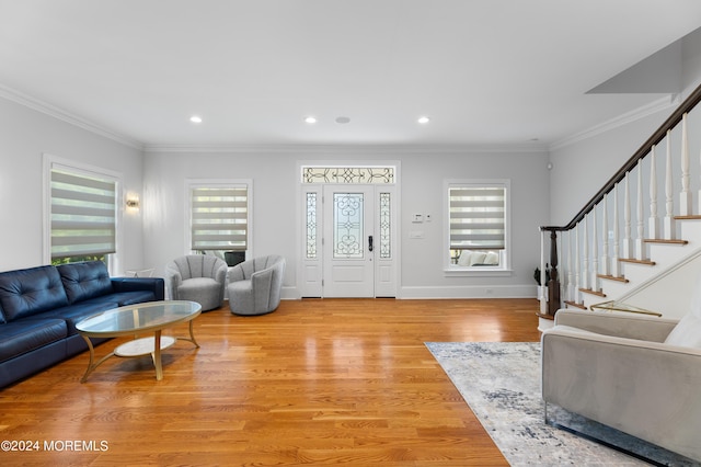 living room with crown molding and light hardwood / wood-style flooring