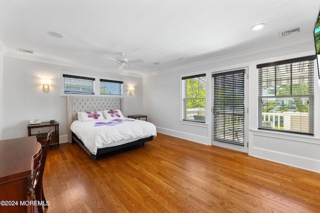 bedroom featuring hardwood / wood-style floors, ceiling fan, and ornamental molding