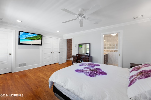 bedroom with hardwood / wood-style floors, ceiling fan, ensuite bathroom, and crown molding