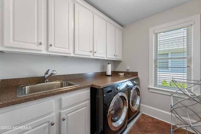 laundry room with sink, cabinets, dark tile patterned floors, and washing machine and dryer