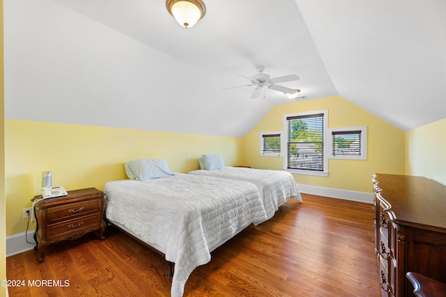 bedroom featuring ceiling fan, vaulted ceiling, and dark hardwood / wood-style flooring