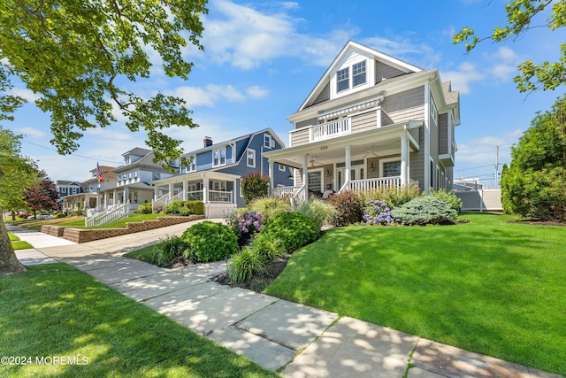 victorian home featuring covered porch and a front lawn