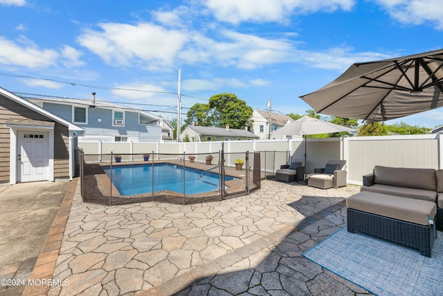 view of swimming pool with an outdoor living space and a patio