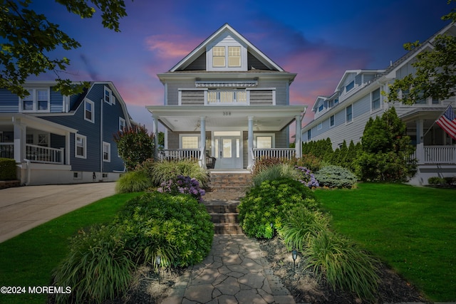 view of front of house featuring a lawn and a porch