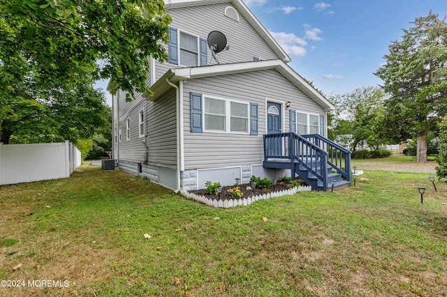 exterior space featuring a front yard and central AC unit