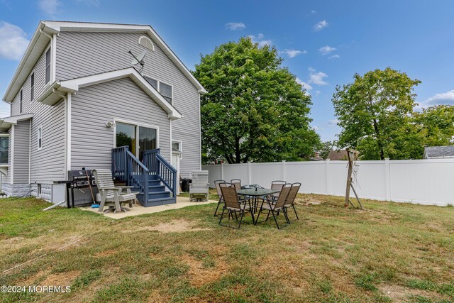 back of house featuring a yard and a patio area