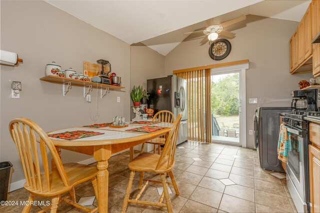 tiled dining room featuring vaulted ceiling, ceiling fan, and washer / clothes dryer