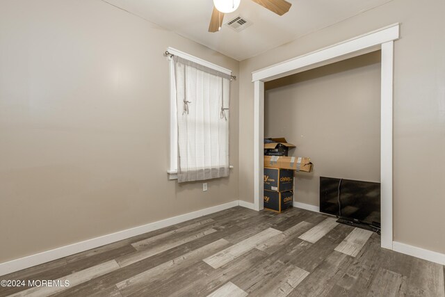 interior space featuring hardwood / wood-style floors, ceiling fan, and a closet