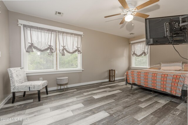 bedroom with hardwood / wood-style floors and ceiling fan