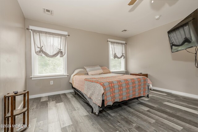 bedroom with ceiling fan and dark hardwood / wood-style floors