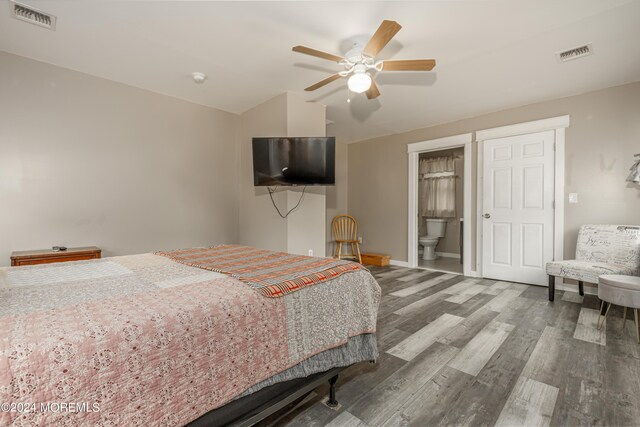 bedroom featuring hardwood / wood-style flooring, ensuite bathroom, and ceiling fan