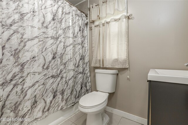 bathroom featuring shower / bath combination with curtain, tile patterned flooring, and toilet