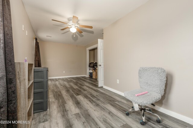 sitting room featuring ceiling fan and wood-type flooring