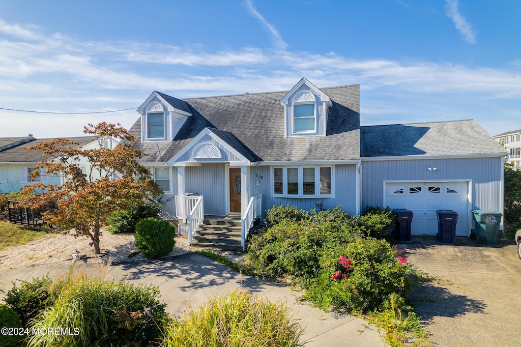 cape cod home with a garage