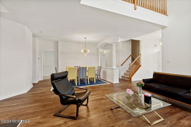 living room with hardwood / wood-style flooring and ornate columns