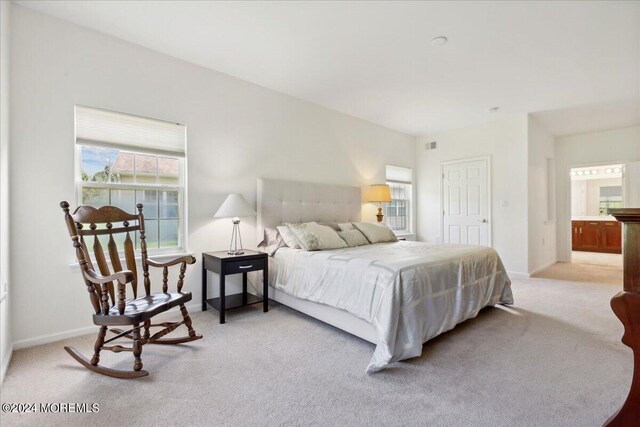 carpeted bedroom featuring connected bathroom