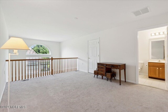 interior space featuring light carpet and sink