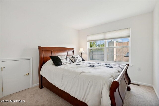 bedroom featuring light colored carpet