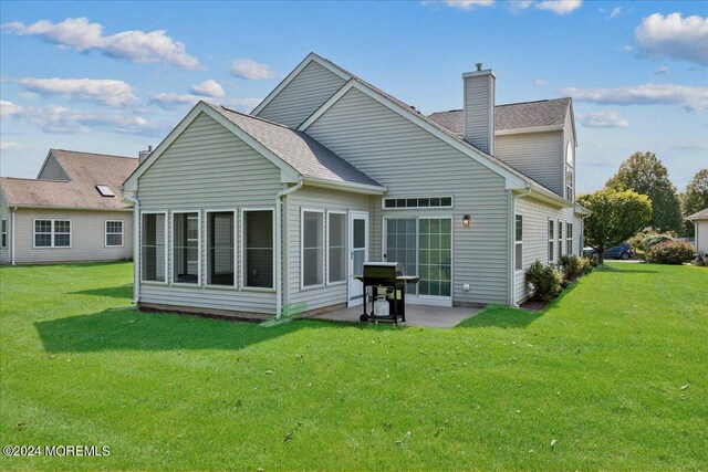 back of house featuring a yard and a patio area