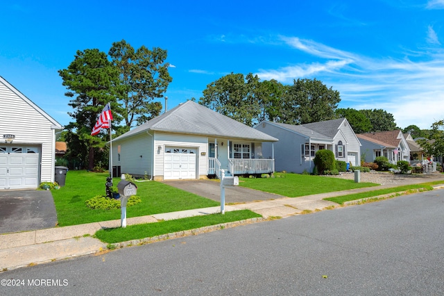 ranch-style home with a front lawn, covered porch, and a garage