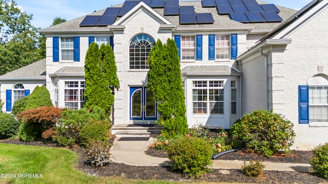 view of front of property featuring solar panels