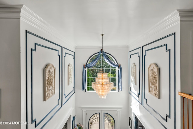 details featuring ornamental molding and a chandelier