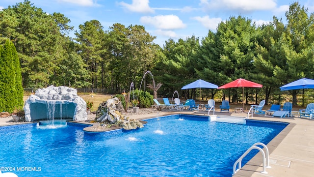 view of pool with a patio area and pool water feature