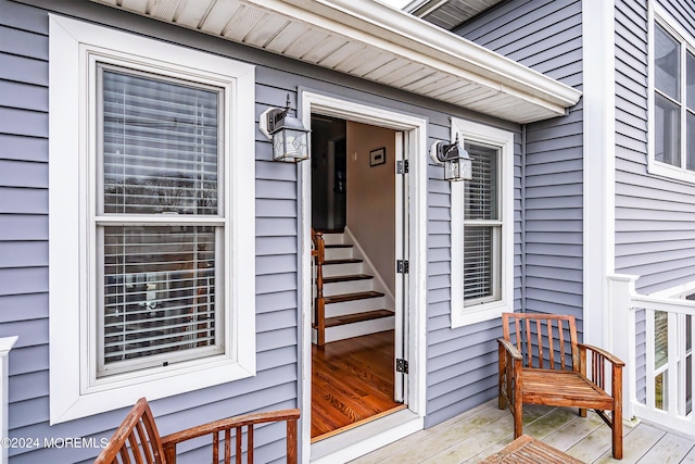 view of exterior entry with a wooden deck